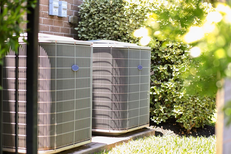 outdoor air conditioning units next to house
