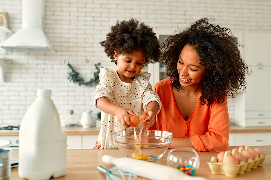 mom and child baking cookies in kitchen