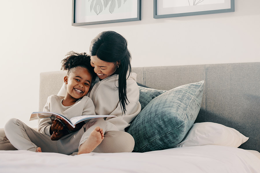 mom and child reading a book together
