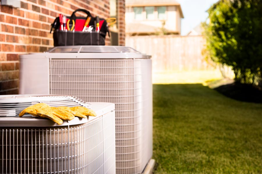 air conditioning unit with tools sitting on top of it